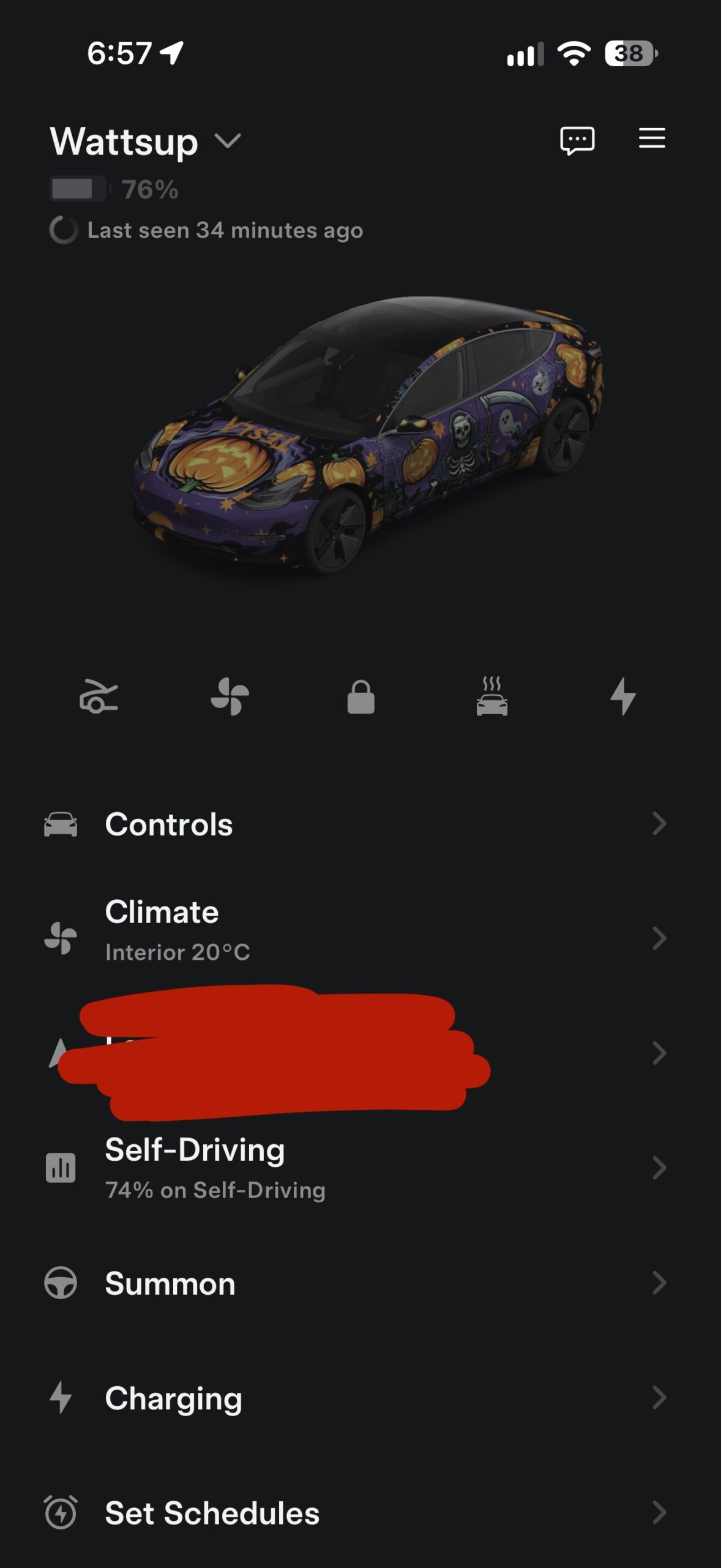 Tesla app screenshot showing the car with a purple Halloween wrap with pumpkins and skeletons